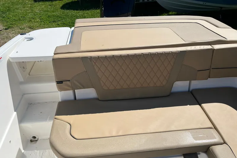Slide: The Image of 2026 Bayliner VR6 Bowrider OB boat with beige cushioned seating and diamond stitching. - 9