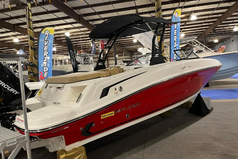 The Image of 2026 Bayliner VR6 Bowrider OB in showroom, red and white design, with canopy. - 0