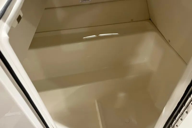 Slide: The Image of 2026 Bayliner VR6 Bowrider OB storage compartment, spacious and clean interior. - 11