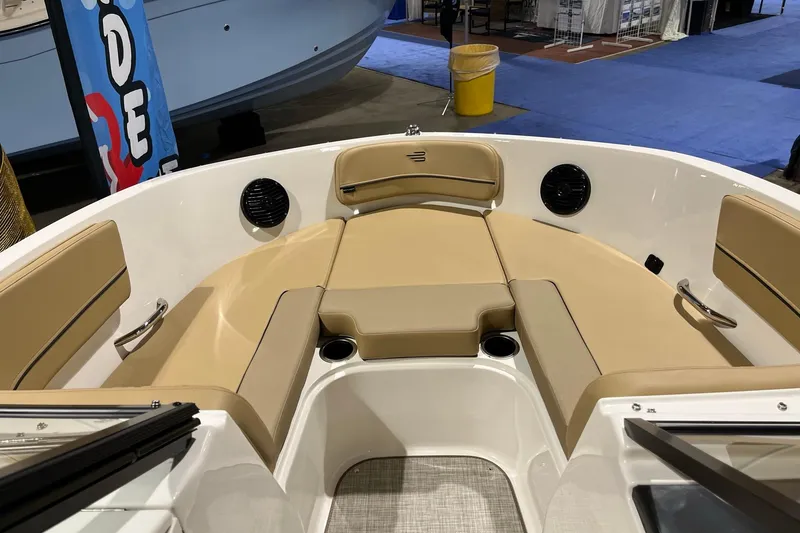 Slide: The Image of 2026 Bayliner VR6 Bowrider OB interior with tan seating and cup holders. - 12