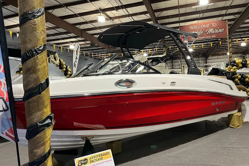 Slide: The Image of 2026 Bayliner VR6 Bowrider OB in showroom, red and white design, indoor display. - 2
