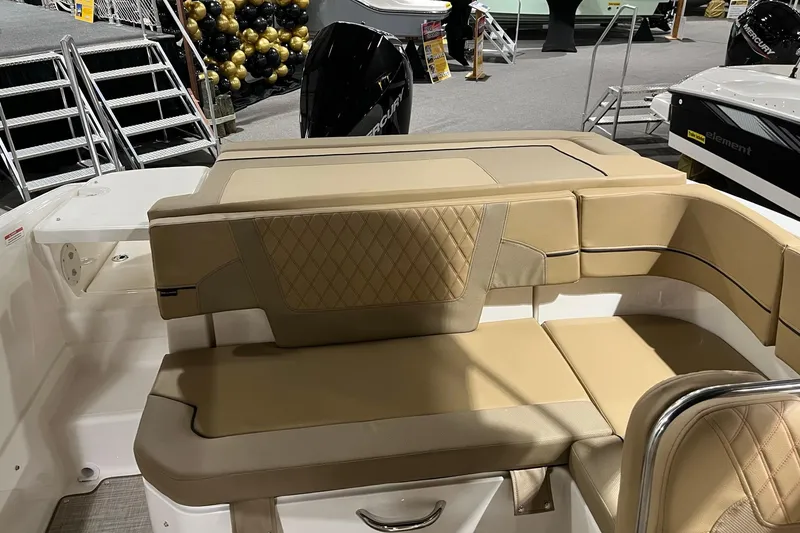 Slide: The Image of 2026 Bayliner VR6 Bowrider OB with tan seating and modern design at a boat show. - 5