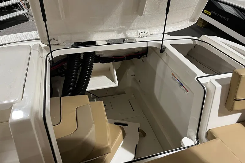 Slide: The Image of 2026 Bayliner VR6 Bowrider OB interior storage compartment with open hatch and seating. - 6