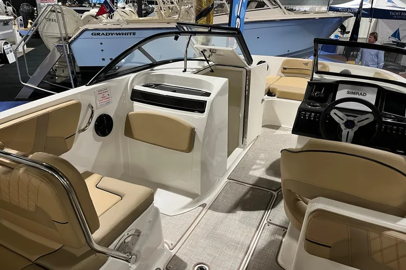 Slide: The Image of 2026 Bayliner VR6 Bowrider OB interior with beige seating and modern dashboard. - 8