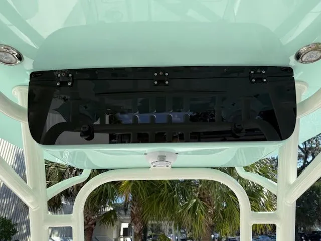 Slide: The Image of Key West 244 Center Console 2020 with T-top and palm trees in background. - 18