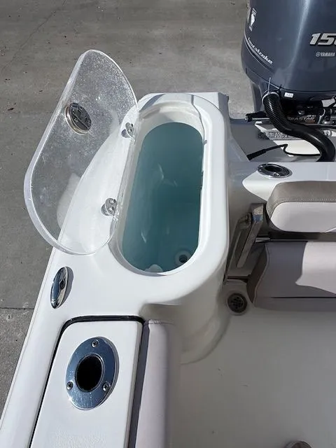 Slide: The Image of Key West 244 Center Console 2020 with open storage compartment. - 27