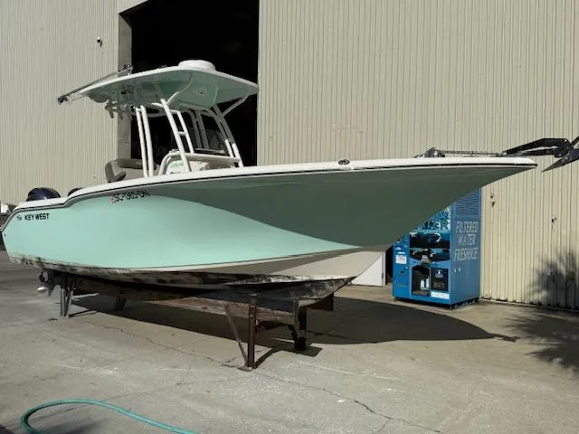 Slide: The Image of 2020 Key West 244 Center Console boat outside warehouse. - 3
