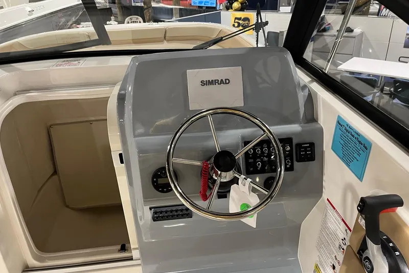 Slide: The Image of 2026 Bayliner Trophy T22SC boat helm with Simrad navigation system and steering wheel. - 10
