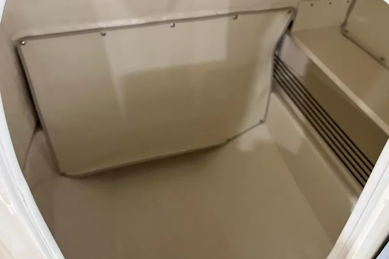 Slide: The Image of 2026 Bayliner Trophy T22SC interior storage compartment, featuring sleek design and ample space. - 11