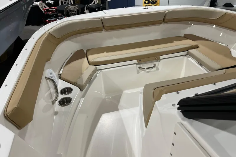 Slide: The Image of 2026 Bayliner Trophy T22SC boat interior with beige seating and cup holders. - 12