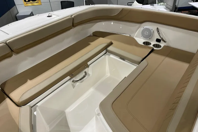 Slide: The Image of 2026 Bayliner Trophy T22SC boat interior with tan seating and storage compartment. - 13
