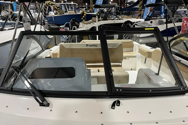 Slide: The Image of 2026 Bayliner Trophy T22SC boat interior with beige seating and windshield. - 15