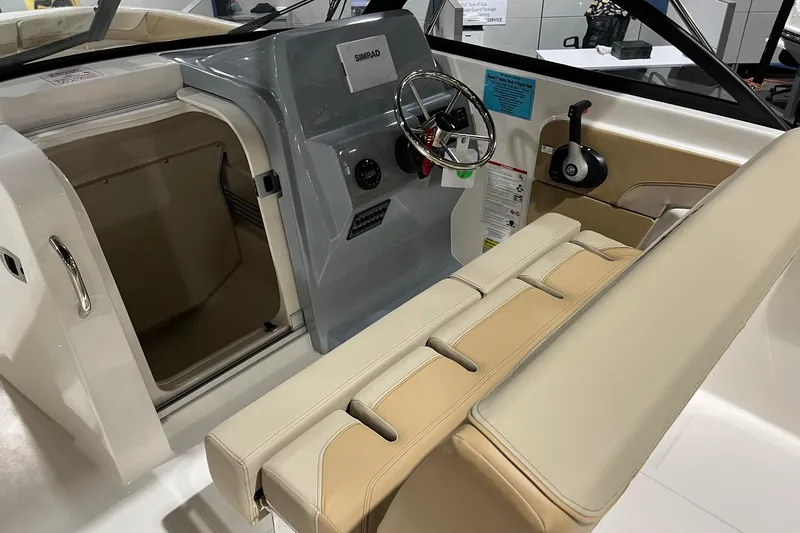 Slide: The Image of 2026 Bayliner Trophy T22SC boat interior with steering wheel and seating. - 8