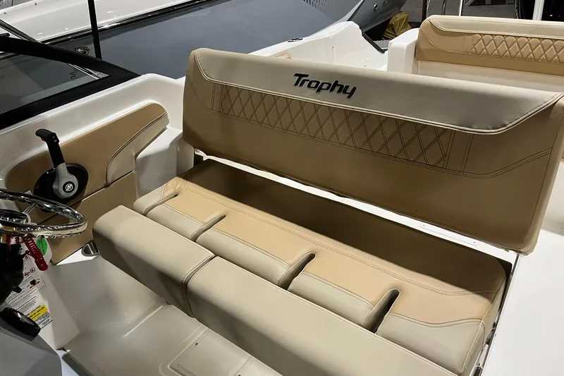 Slide: The Image of 2026 Bayliner Trophy T22SC boat interior with beige seating and steering wheel. - 9