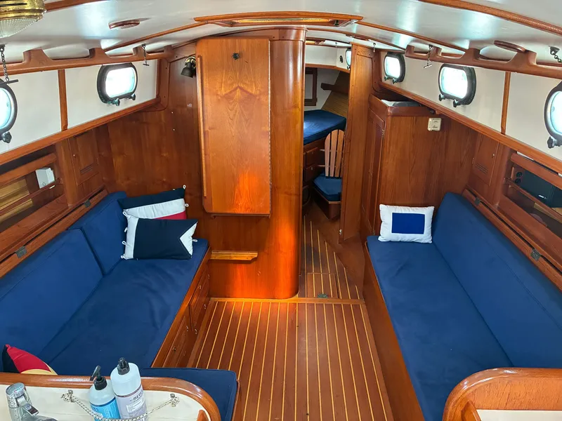 Slide: The Image of Interior of a 2001 Cape Dory Robinhood 36 with wood finish and blue upholstery. - 35