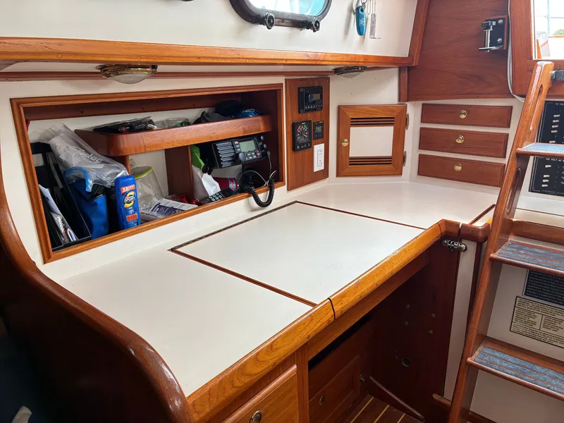 Slide: The Image of Interior of a 2001 Cape Dory Robinhood 36 with wood paneling and storage space. - 38