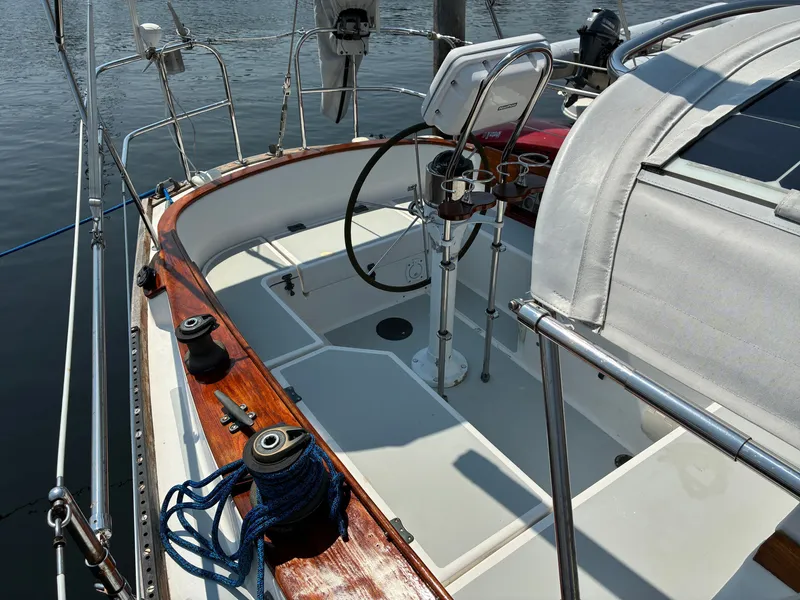 Slide: The Image of The cockpit of a 2001 Cape Dory Robinhood 36 with wood accents and a steering wheel. - 23