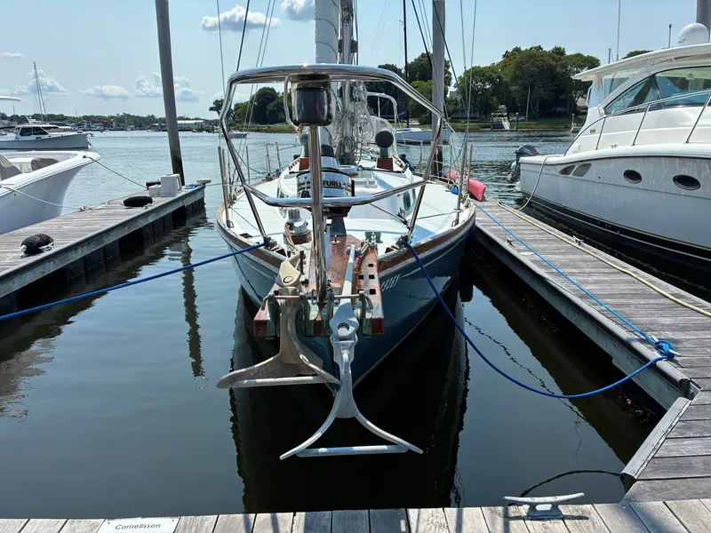 Slide: The Image of Cape Dory Robinhood 36 sailboat from 2001 docked in a marina, surrounded by other boats. - 10