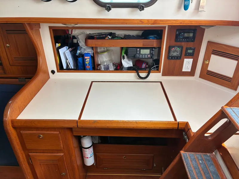 Slide: The Image of Interior of a 2001 Cape Dory Robinhood 36 with wooden cabinets and navigation equipment. - 39