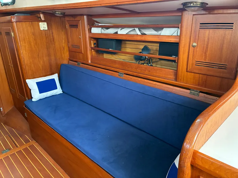Slide: The Image of Interior of a 2001 Cape Dory Robinhood 36 with blue upholstery and wooden finish. - 48