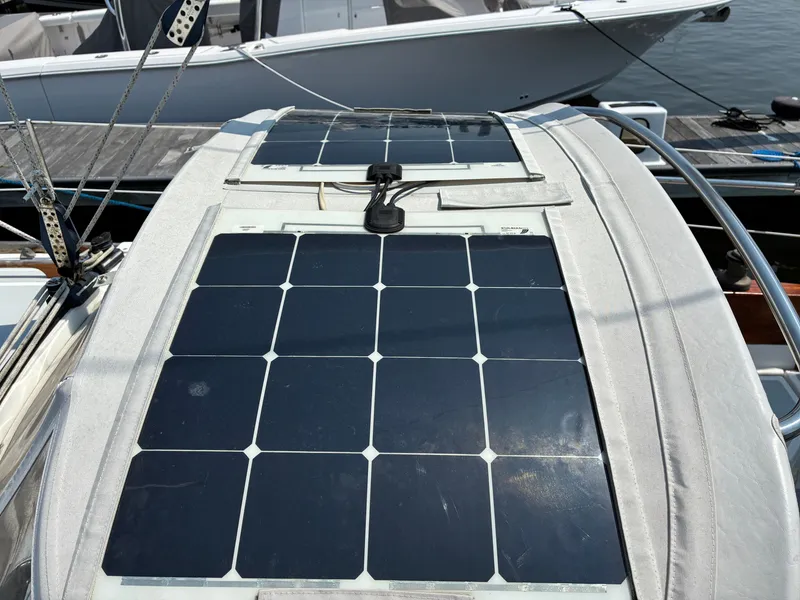 Slide: The Image of Solar panels on the deck of a 2001 Cape Dory Robinhood 36, docked at a marina. - 24