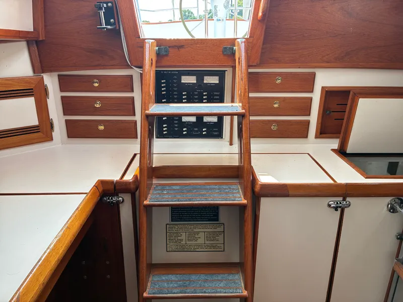 Slide: The Image of Interior of a 2001 Cape Dory Robinhood 36 with wooden steps and cabinets. - 37