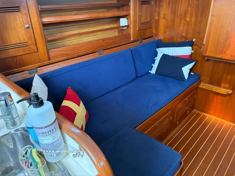 Slide: The Image of Interior of a 2001 Cape Dory Robinhood 36 with blue upholstery and wooden finish. - 45