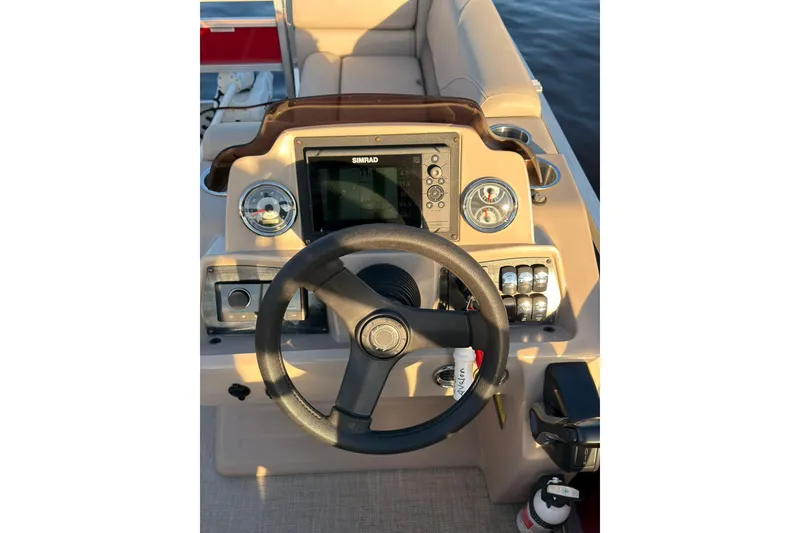 Slide: The Image of Steering console of 2021 Avalon VENTURE 1875 boat with navigation controls. - 11