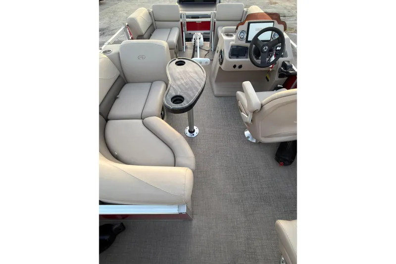 Slide: The Image of 2021 Avalon VENTURE 1875 boat interior with beige seating and steering console. - 17