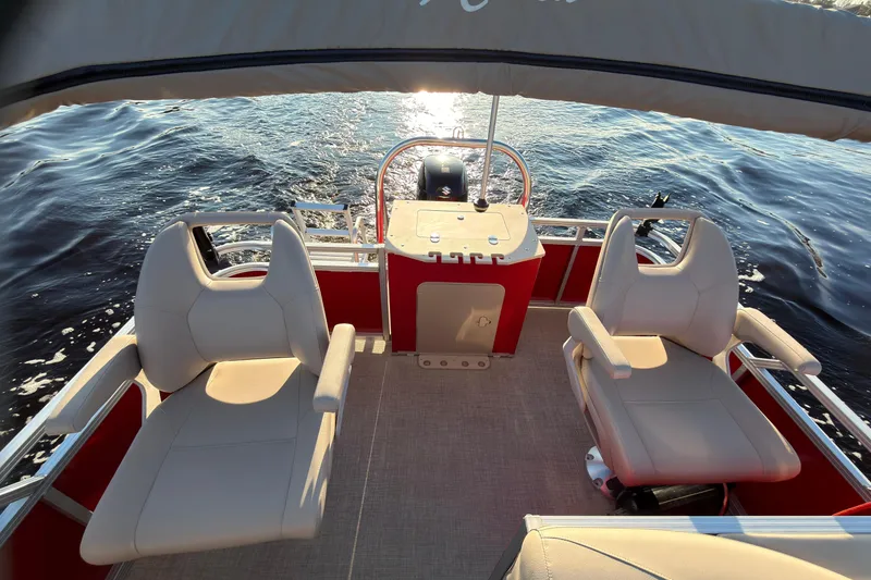 Slide: The Image of 2021 Avalon VENTURE 1875 boat interior with two seats, on calm water. - 20
