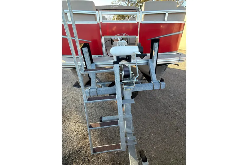 Slide: The Image of 2021 Avalon VENTURE 1875 boat on trailer, rear view with red exterior. - 25