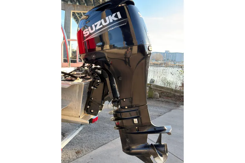Slide: The Image of Suzuki outboard motor on 2021 Avalon VENTURE 1875 boat, dockside view. - 6