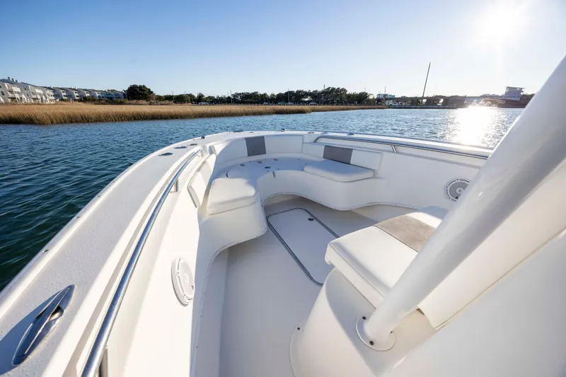 Slide: The Image of 2014 Cape Horn 27 XS boat interior with seating, on calm water under clear sky. - 10