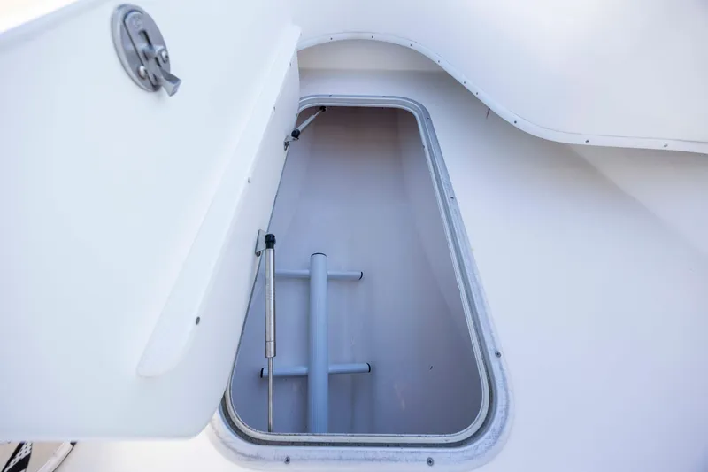 Slide: The Image of Open storage compartment on 2014 Cape Horn 27 XS boat. - 12