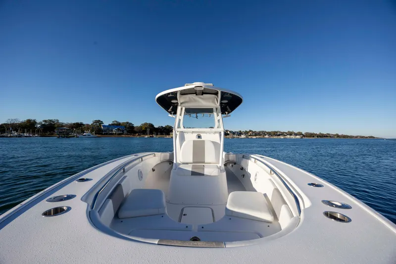 Slide: The Image of 2014 Cape Horn 27 XS boat on calm water under clear blue sky. - 14