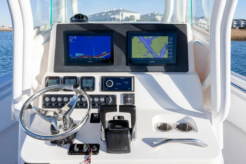 Slide: The Image of Control panel of a 2014 Cape Horn 27 XS boat with navigation screens. - 18