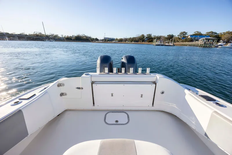 Slide: The Image of 2014 Cape Horn 27 XS boat on calm water, featuring dual outboard motors. - 23