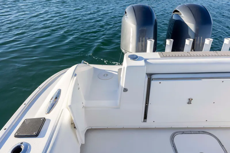 Slide: The Image of 2014 Cape Horn 27 XS boat stern with dual outboard motors on water. - 25
