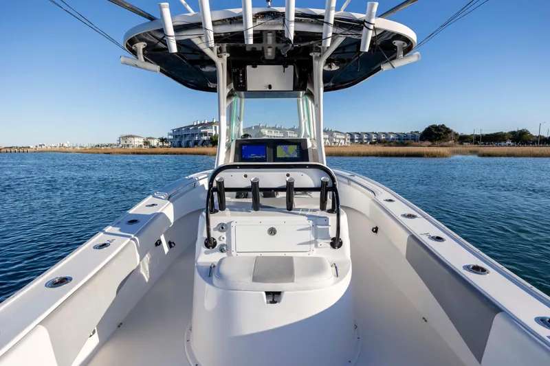 Slide: The Image of 2014 Cape Horn 27 XS boat on calm water, featuring a modern console and seating. - 27