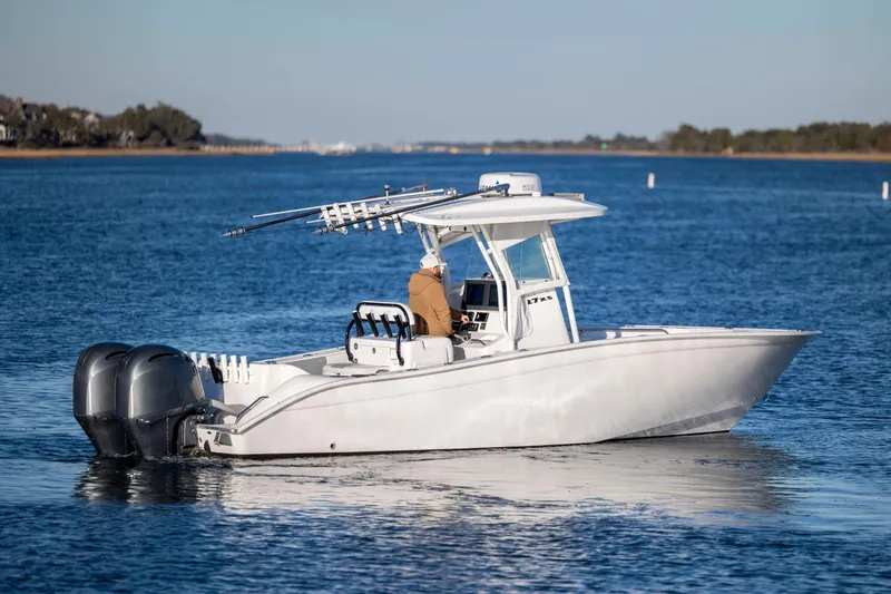 Slide: The Image of 2014 Cape Horn 27 XS boat cruising on calm blue water. - 3