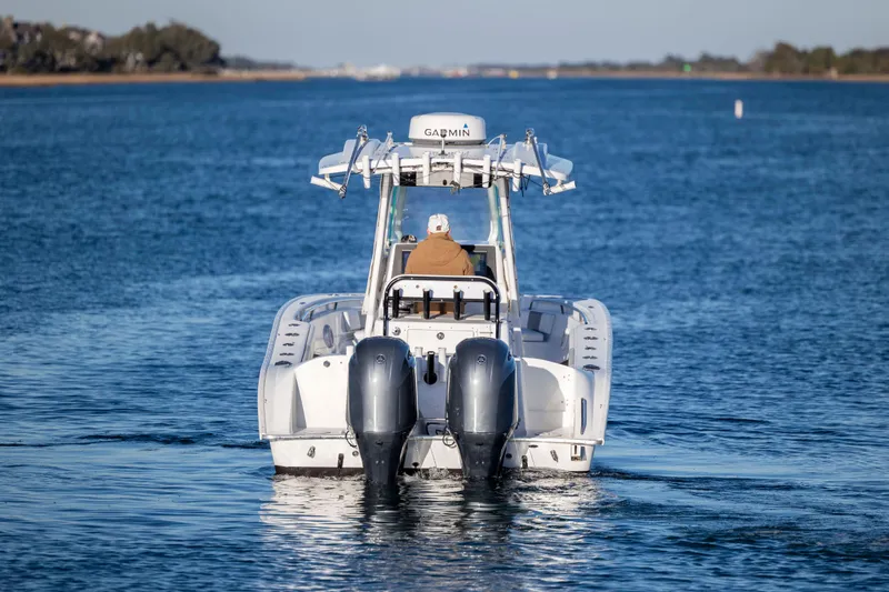 Slide: The Image of 2014 Cape Horn 27 XS boat cruising on a calm blue waterway. - 4