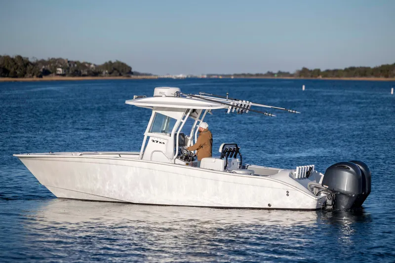 Slide: The Image of 2014 Cape Horn 27 XS boat on calm blue water, side view. - 6