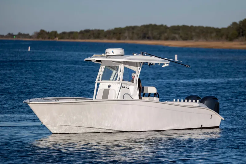 Slide: The Image of 2014 Cape Horn 27 XS boat cruising on a calm blue lake. - 8