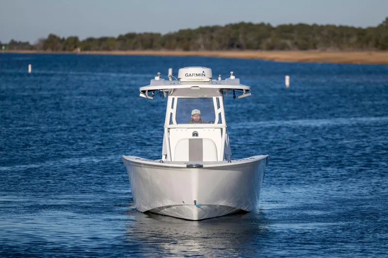 Slide: The Image of 2014 Cape Horn 27 XS boat navigating on calm blue water. - 9