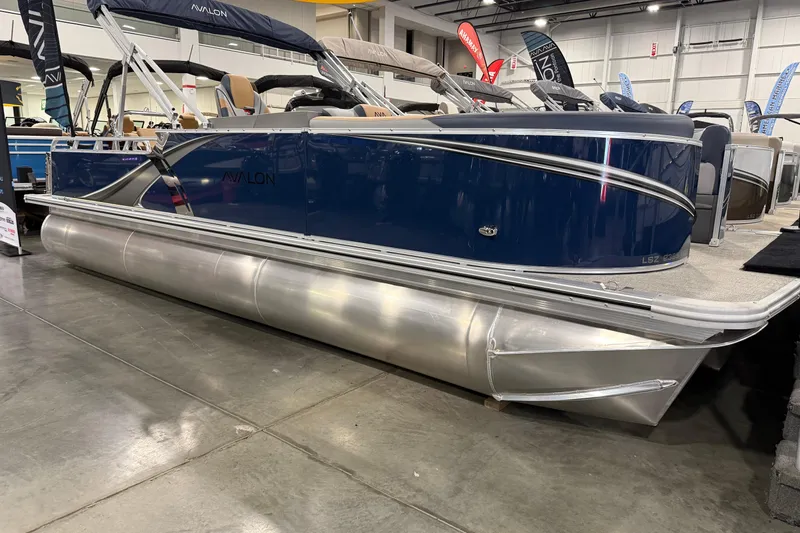 The Image of 2026 Avalon 2385 LSZ VRB pontoon boat displayed indoors, featuring sleek blue design. - 0
