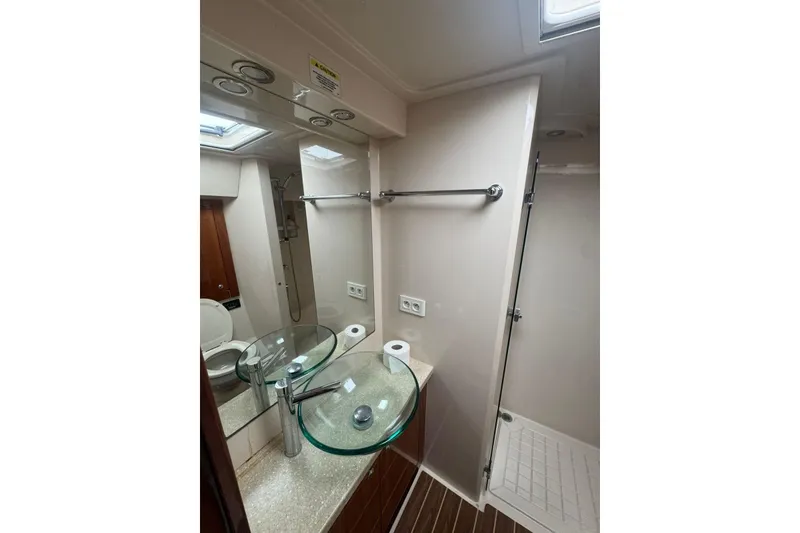 Slide: The Image of Luxurious bathroom in 2009 Riviera 4700 Sport Yacht with glass sink and modern fixtures. - 4