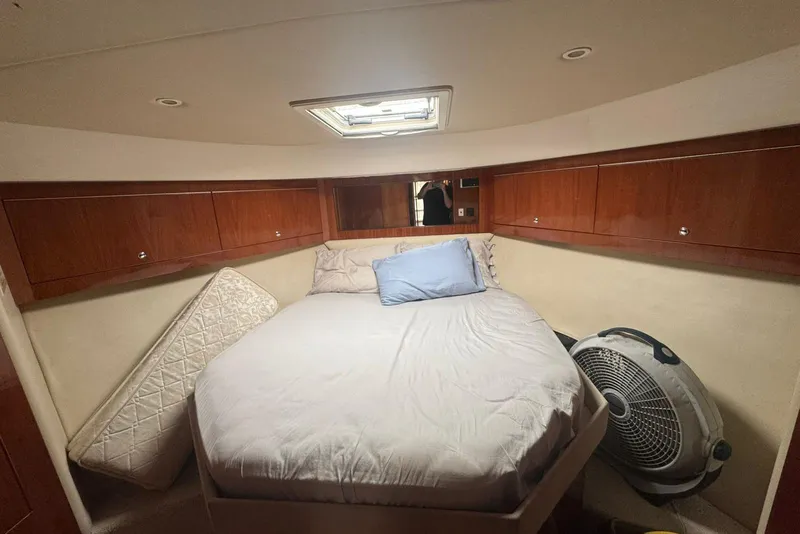Slide: The Image of Cozy bedroom in 2009 Riviera 4700 Sport Yacht with wooden cabinets and skylight. - 5