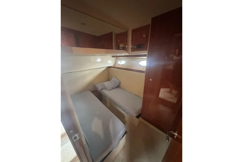 Slide: The Image of Interior cabin of 2009 Riviera 4700 Sport Yacht with twin beds and wooden finish. - 6
