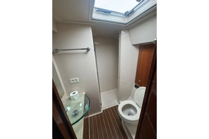 Slide: The Image of Bathroom interior of 2009 Riviera 4700 Sport Yacht with modern fixtures and skylight. - 8