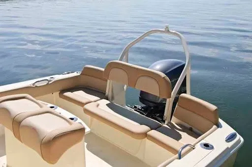 Slide: The Image of 2017 Scout 195 Sportfish with beige interior on calm water. - 5